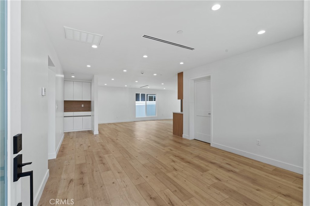 13901 Runnymede Street Van Nuys, CA 91405 - Photo 8 of 47 an empty room with wooden floor and windows