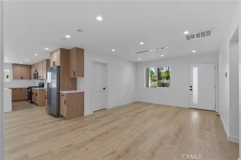 a view of a kitchen with a sink and a refrigerator