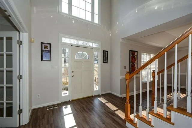 a view of an entryway with wooden floor and door