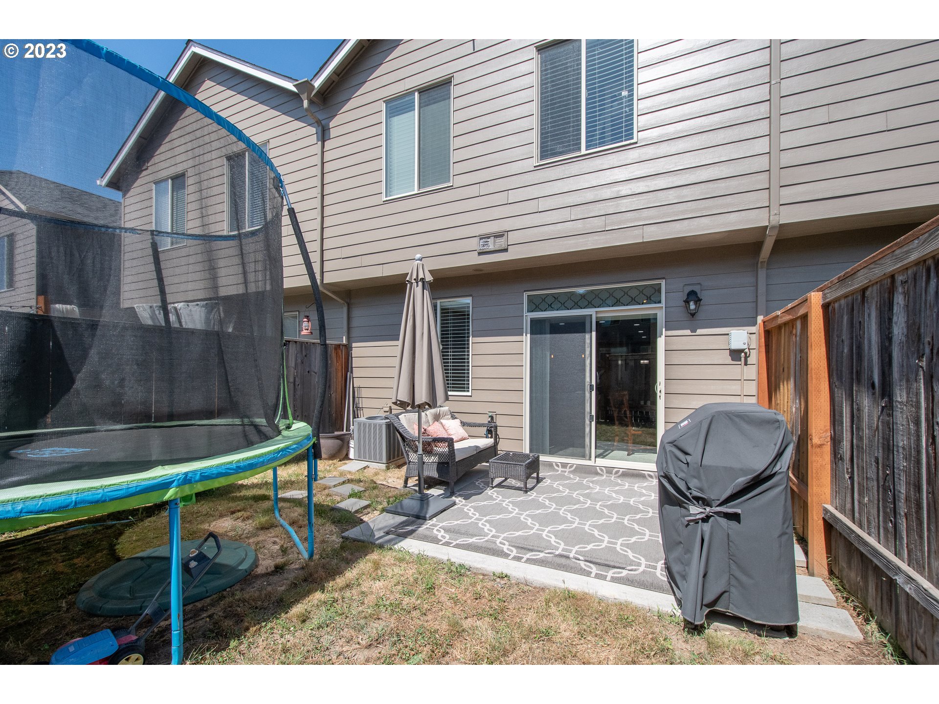 3309 North 3rd Street Ridgefield, WA 98642 - Photo 30 of 36 a backyard of a house with seating space and barbeque oven