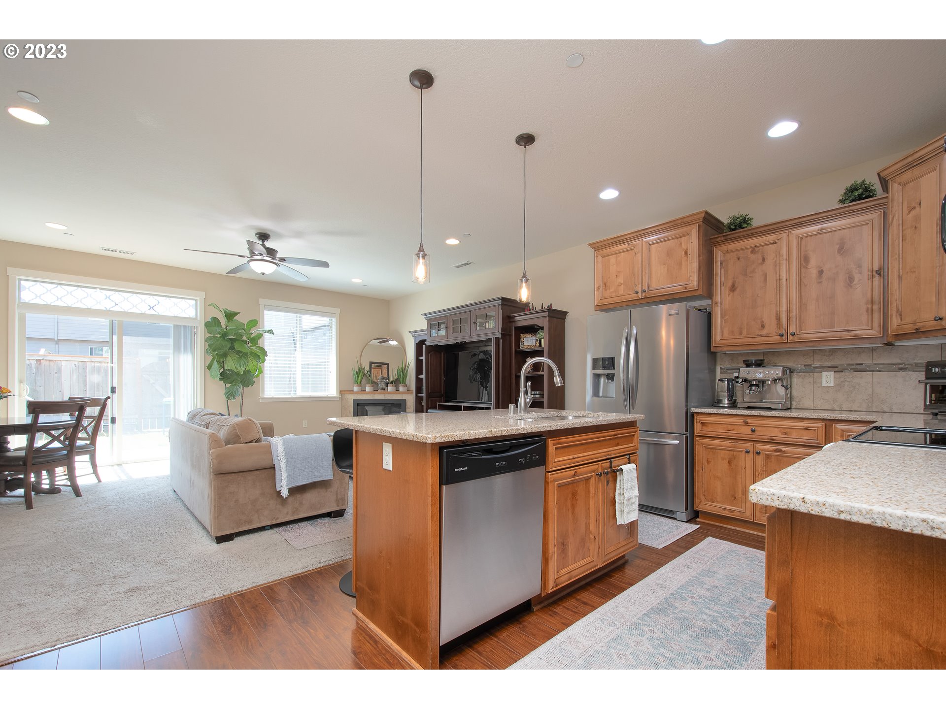 3309 North 3rd Street Ridgefield, WA 98642 - Photo 4 of 36 a kitchen with stainless steel appliances kitchen island granite countertop a stove and a refrigerator