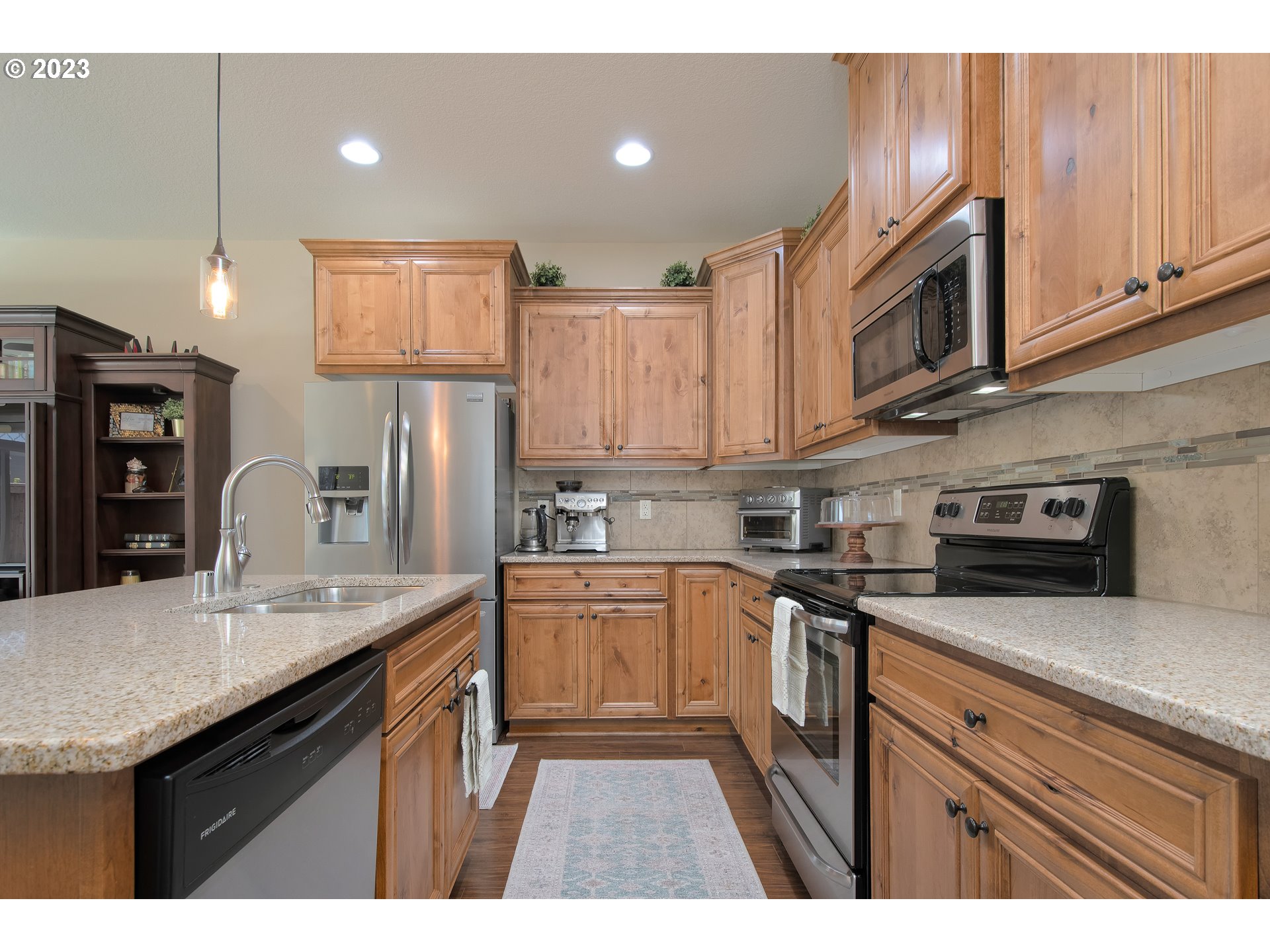 3309 North 3rd Street Ridgefield, WA 98642 - Photo 5 of 36 a kitchen with stainless steel appliances granite countertop a sink stove and refrigerator
