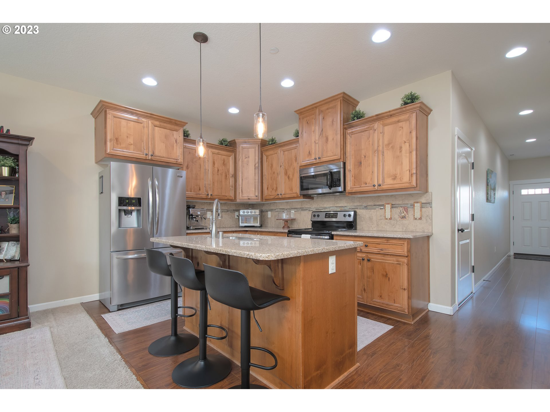 3309 North 3rd Street Ridgefield, WA 98642 - Photo 6 of 36 a kitchen with stainless steel appliances granite countertop a sink a stove a refrigerator and a microwave