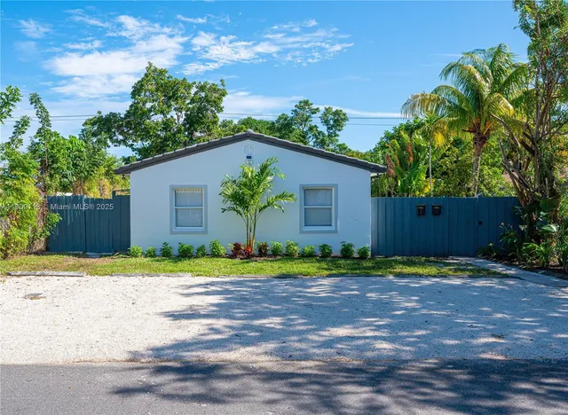 a house that has a tree in front of it