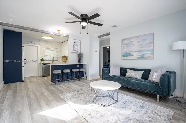 a living room with furniture a clock and a chandelier
