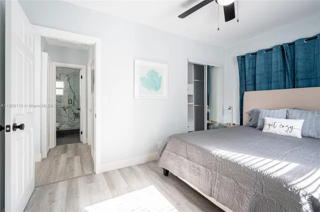 a bedroom with a large bed and a chandelier