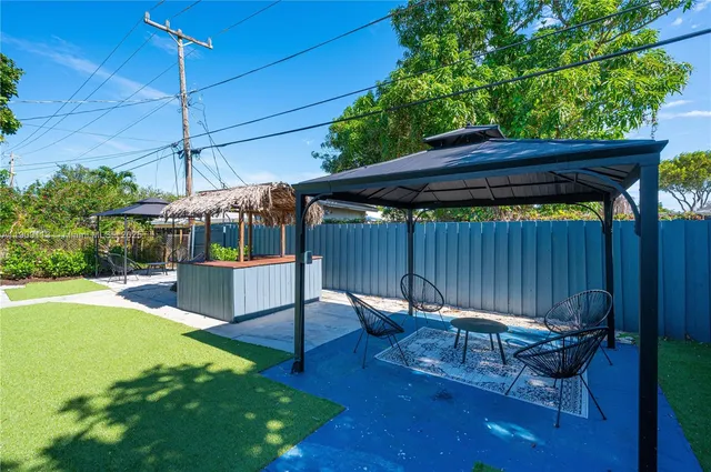 a view of a backyard with sitting area furniture and garden