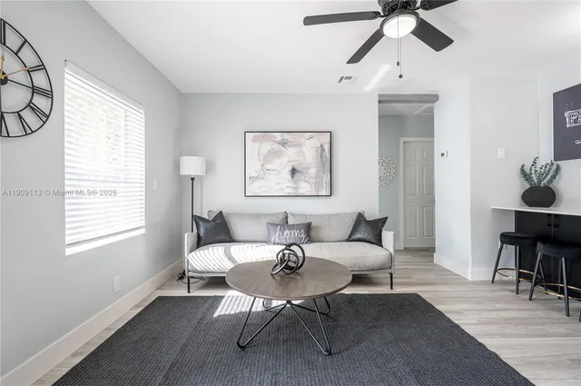 a living room with furniture a table and a window