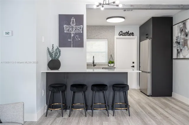 a view of a kitchen with a table and chairs