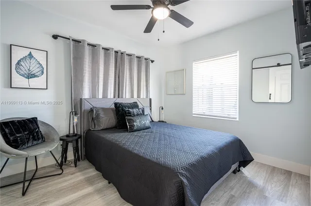 a spacious bedroom with a bed and a window