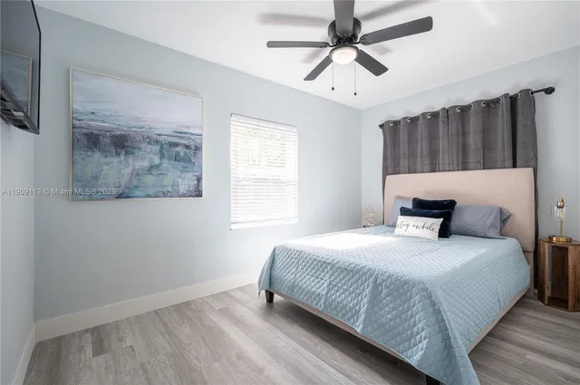 a bedroom with a large bed and a window