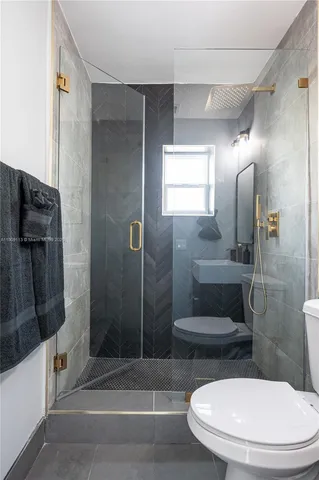 a bathroom with a toilet and a shower