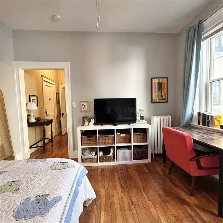 1572 Commonwealth Avenue, Unit 3 Boston, MA 02135 - Photo 3 of 6 a living room with furniture and a flat screen tv