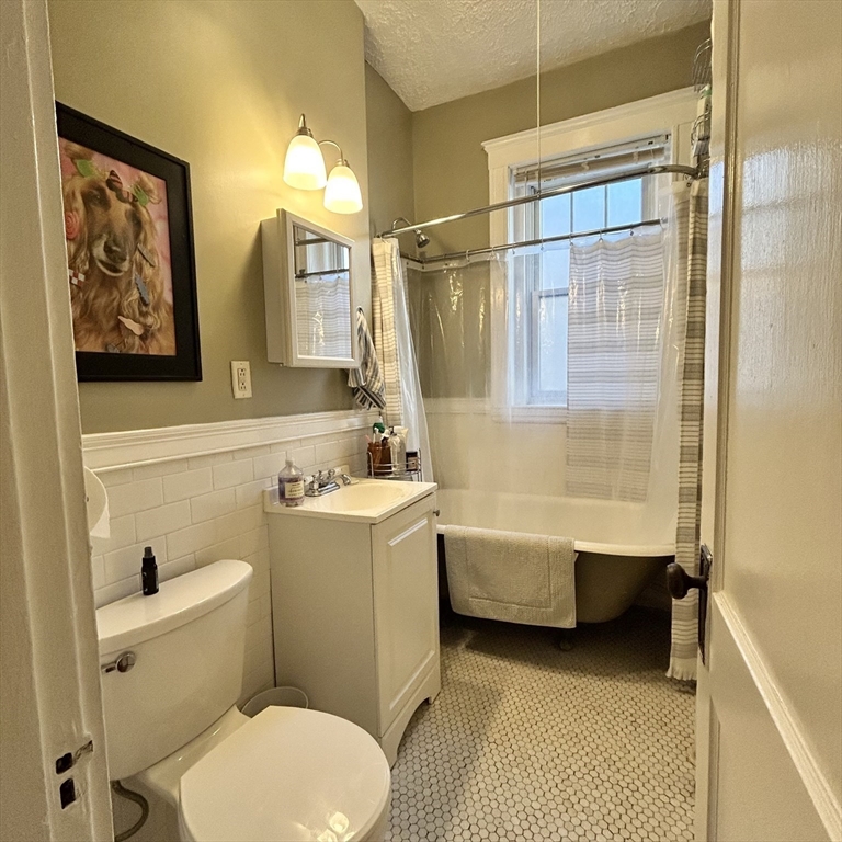 1572 Commonwealth Avenue, Unit 3 Boston, MA 02135 - Photo 4 of 6 a bathroom with a sink toilet and bathtub