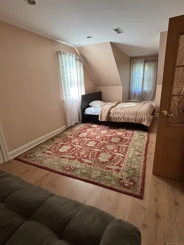 a bedroom with a large bed and a window