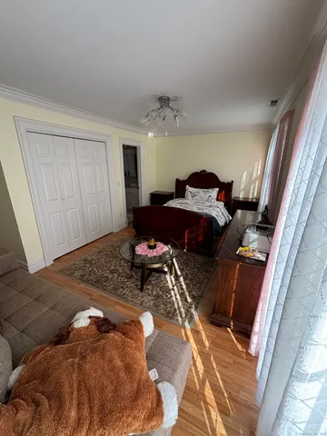 a bedroom with a bed and window