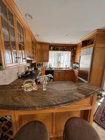 a kitchen with sink refrigerator and window