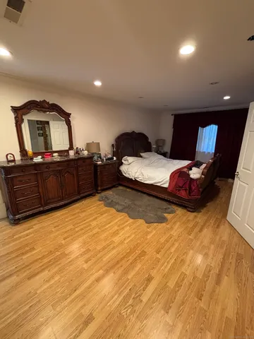 a bedroom with a bed and dresser