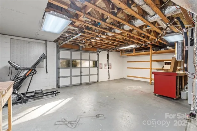 a bedroom with furniture and a large window