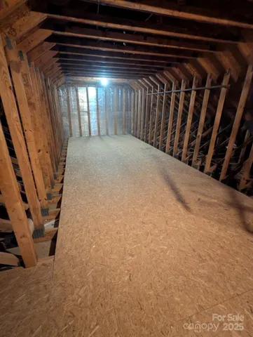 a front view of a house with a garden and trees