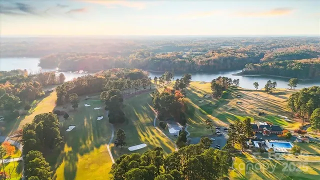 a view of a house with a yard and tree