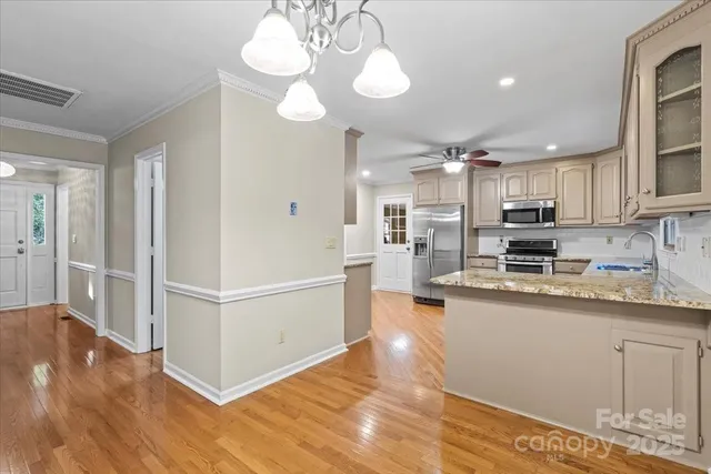 a kitchen with stainless steel appliances granite countertop a stove and a refrigerator