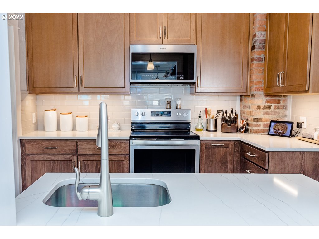 904 E Street Springfield, OR 97477 - Photo 23 of 31 a kitchen with stainless steel appliances wooden cabinets a stove and a sink