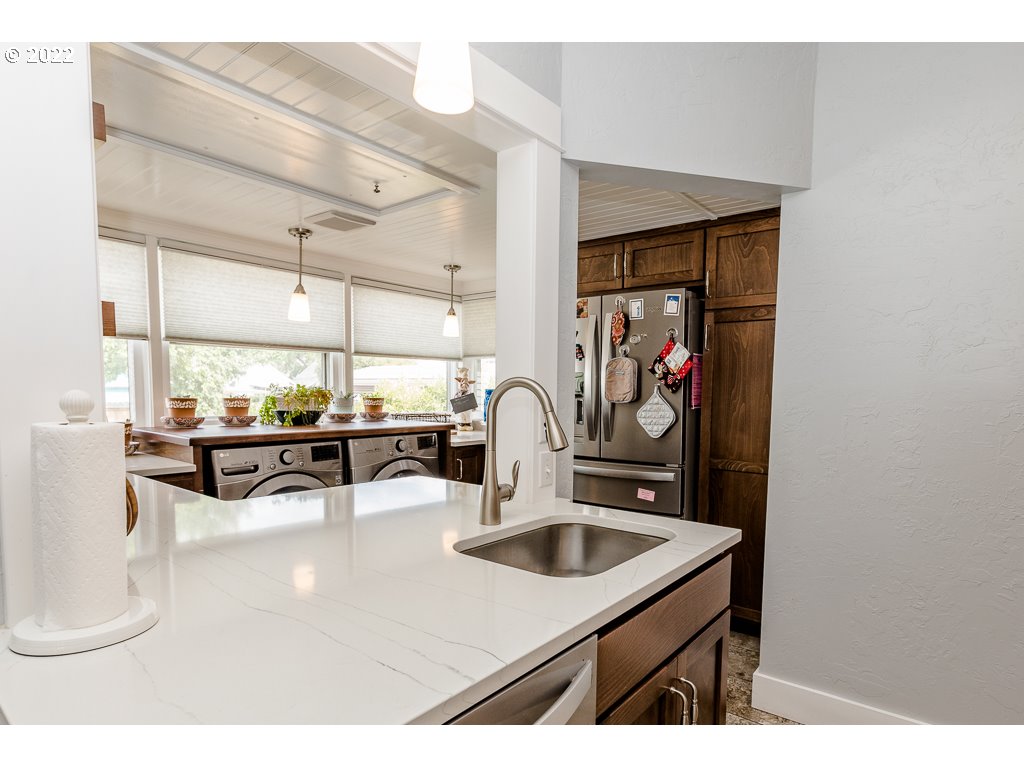904 E Street Springfield, OR 97477 - Photo 24 of 31 a kitchen with a sink and a refrigerator