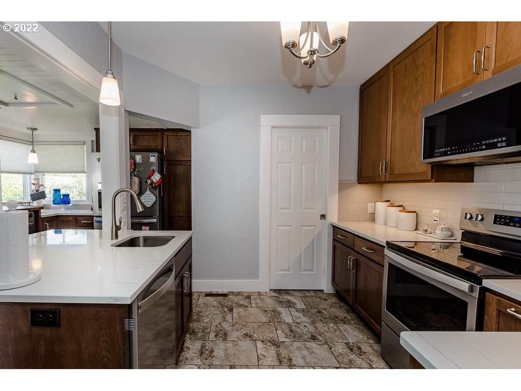 904 E Street Springfield, OR 97477 - Photo 25 of 31 a kitchen with stainless steel appliances a sink stove and microwave
