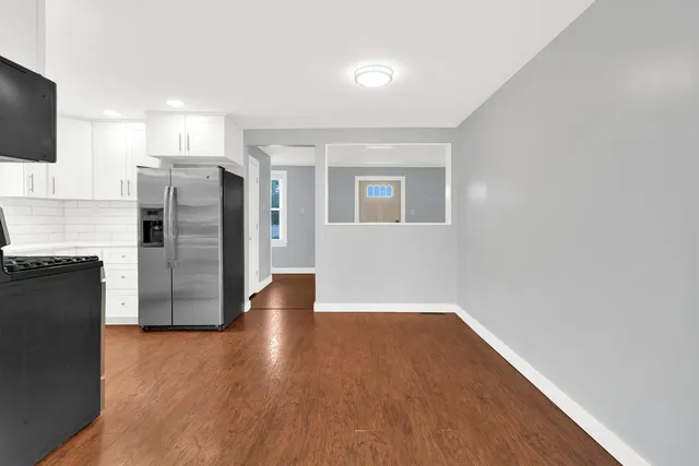 a view of a kitchen with a refrigerator a stove top oven and a dishwasher