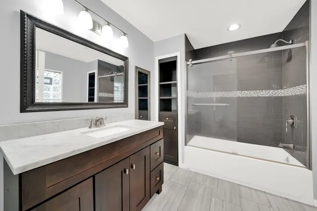 a bathroom with a sink a mirror and a bathtub