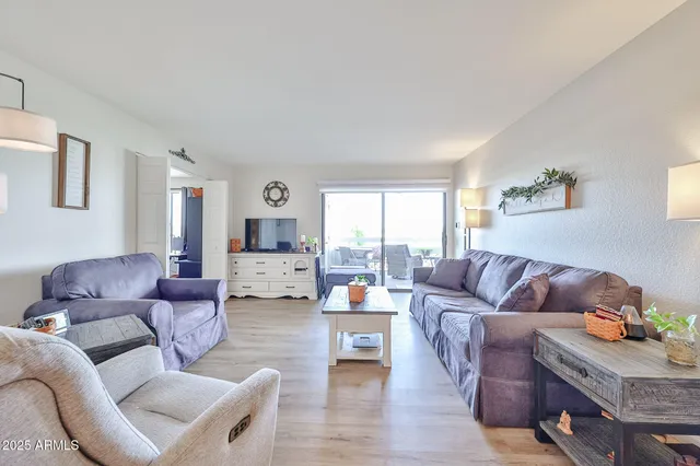 a living room with furniture or couch and a wooden floor
