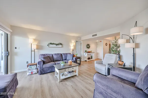 a living room with furniture and a wooden floor