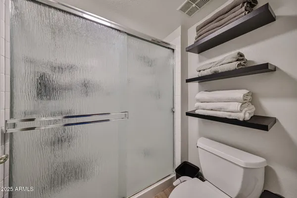 a bathroom with a shower and a sink