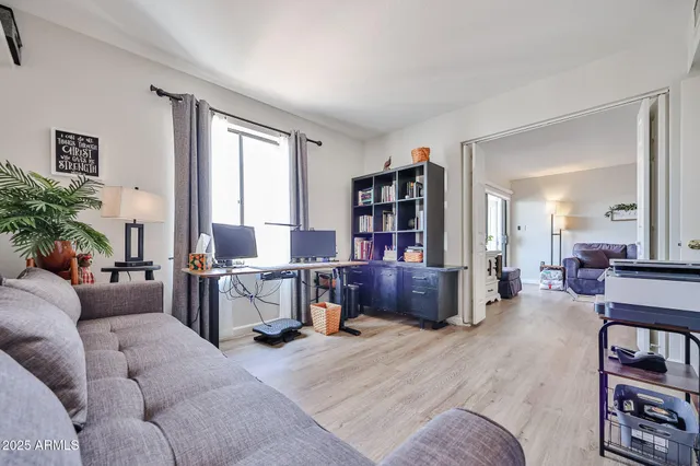 a living room with furniture and a wooden floor