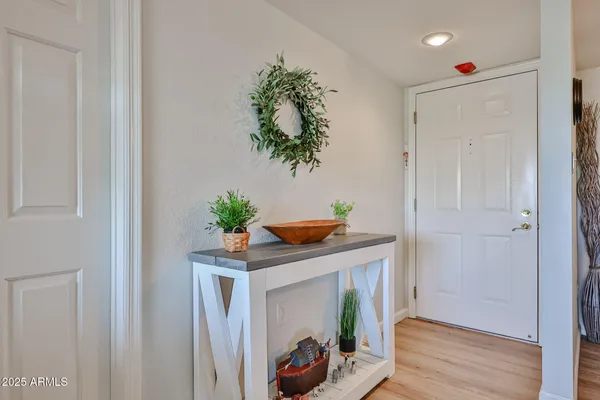 a hallway with painting and wooden floor