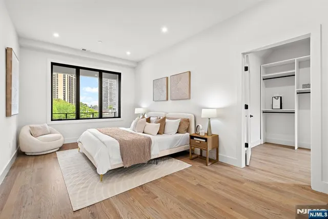 a spacious bedroom with a bed and window