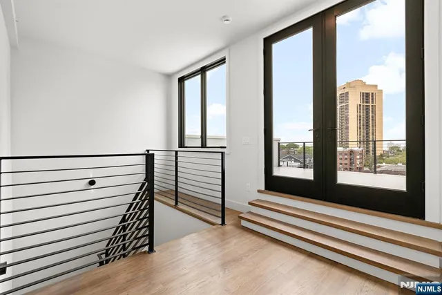 a view of a room with stairs and a large window