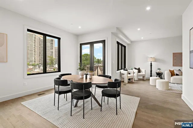 a living room with furniture and large windows