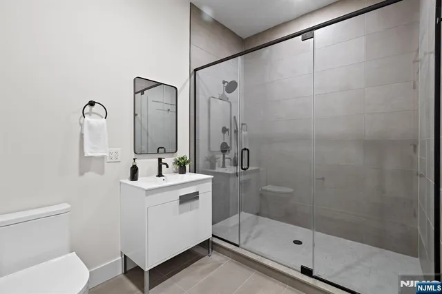 a bathroom with a sink mirror toilet and shower