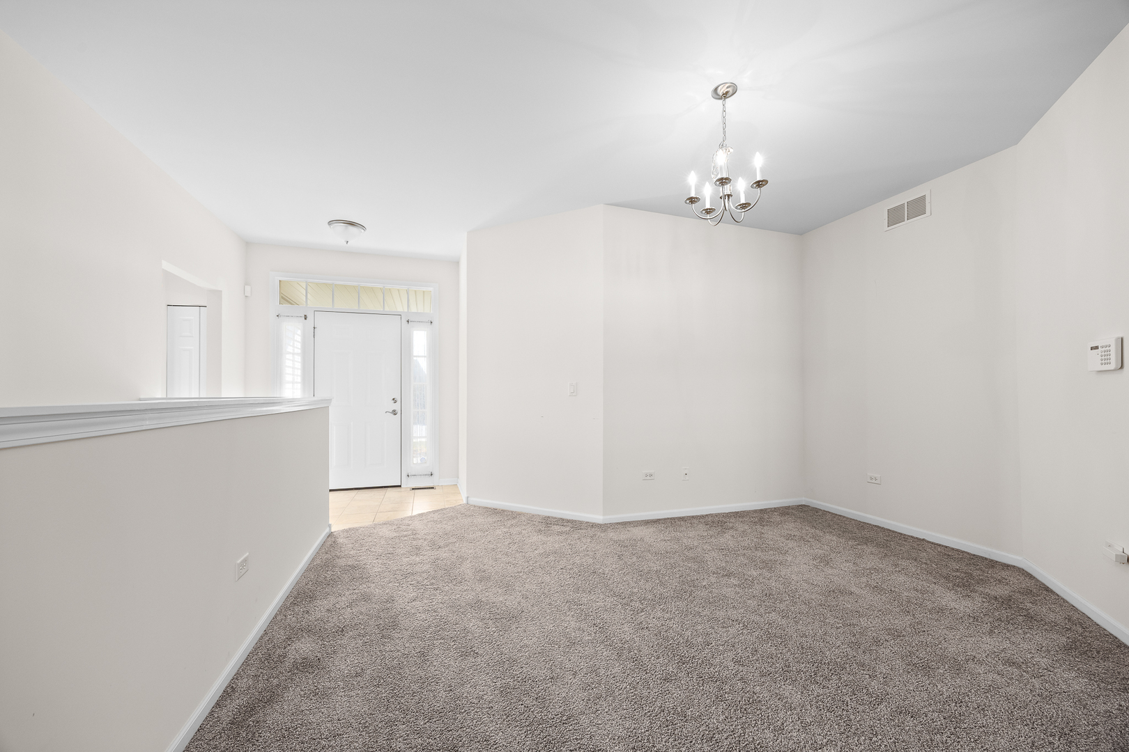 17340 Lucerne Court Lockport, IL 60441 - Photo 8 of 27 an empty room with chandelier fan