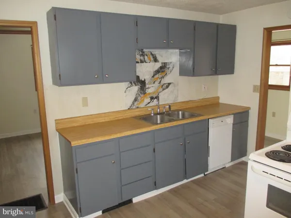 a utility room with cabinets washer and dryer