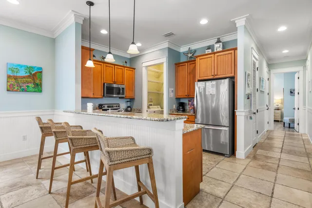 a kitchen with stainless steel appliances granite countertop a stove a sink and a refrigerator