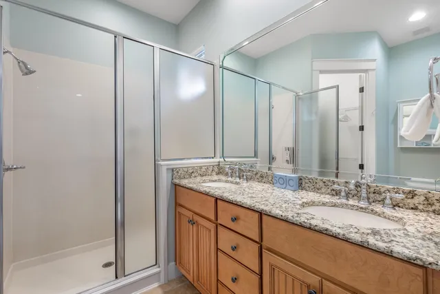 a bedroom with two beds and painting on the wall