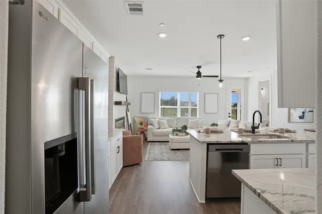 a kitchen with stainless steel appliances granite countertop a sink stove and refrigerator