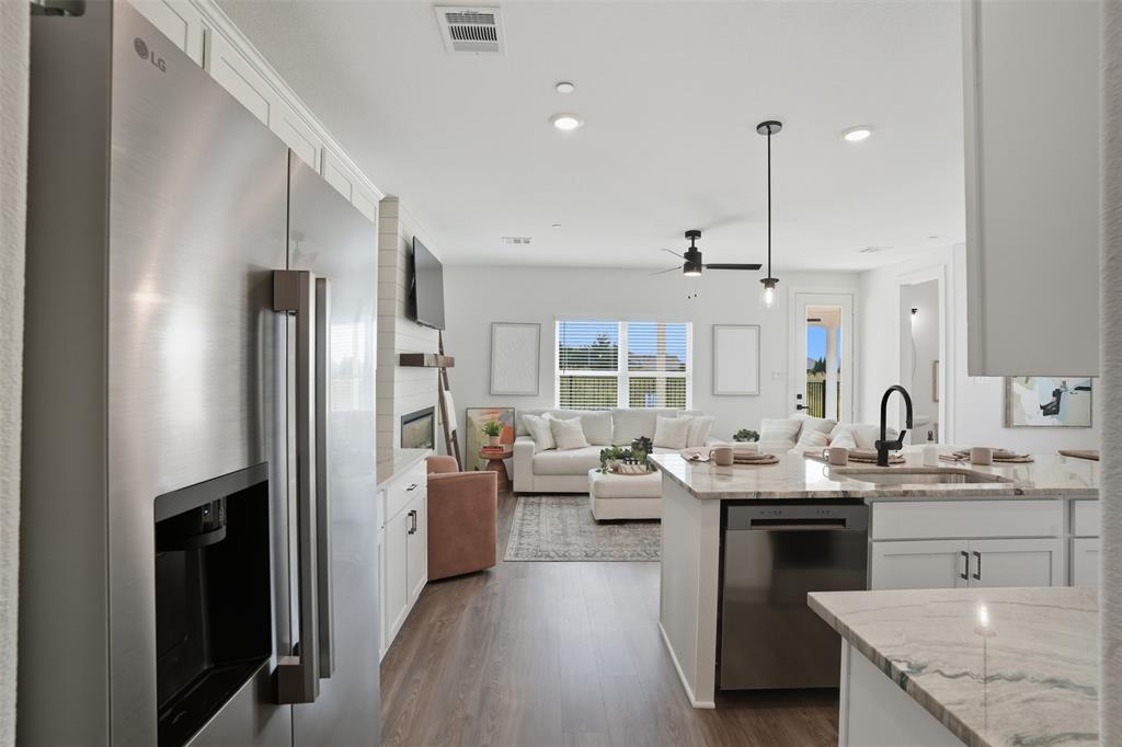 1622 Governors Boulevard Forney, TX 75126 - Photo 14 of 38 a kitchen with stainless steel appliances granite countertop a sink stove and refrigerator