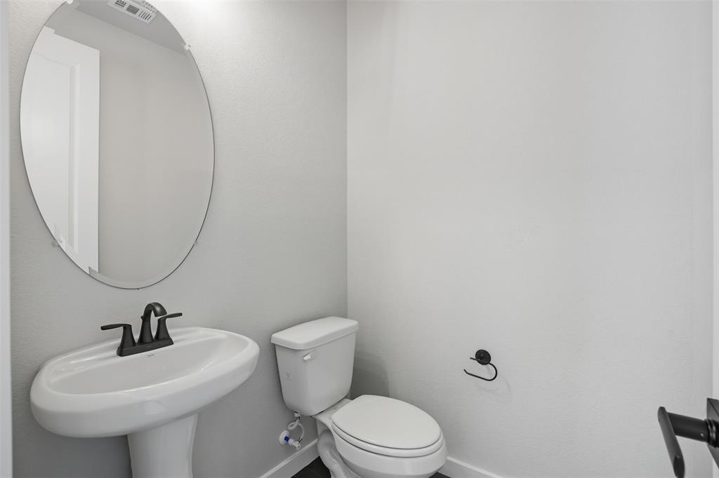 1622 Governors Boulevard Forney, TX 75126 - Photo 16 of 38 a bathroom with a sink a toilet and a mirror
