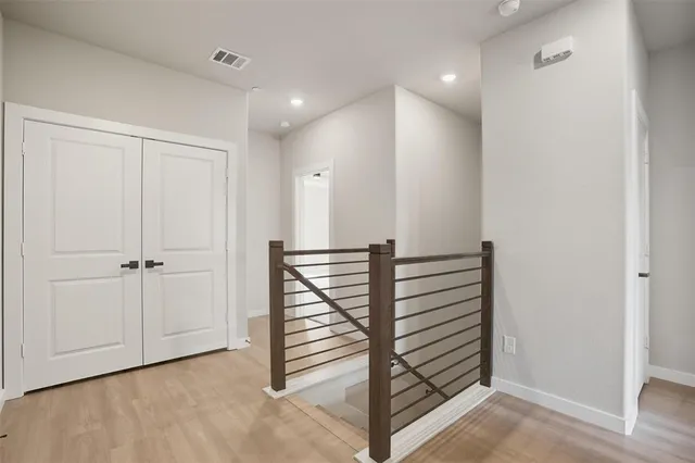 a view of a hallway with stairs