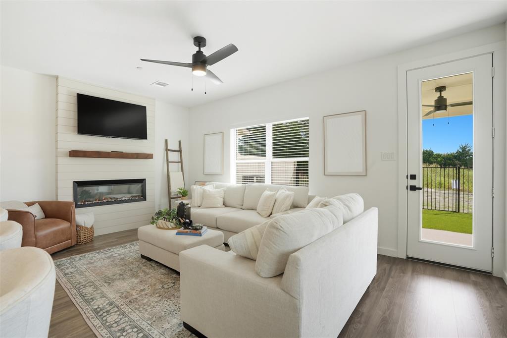 1622 Governors Boulevard Forney, TX 75126 - Photo 8 of 38 a living room with furniture fireplace and a flat screen tv