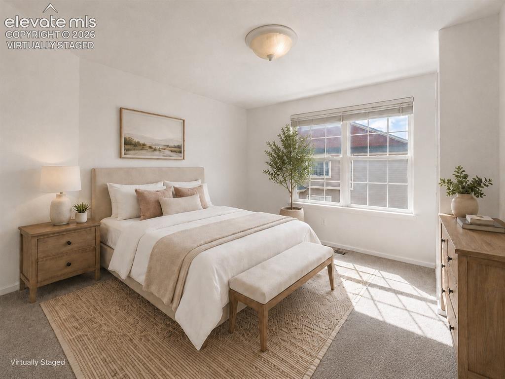 1563 Monterey Road, Unit D Colorado Springs, CO 80910 - Photo 11 of 22 a bedroom with a large bed and a window